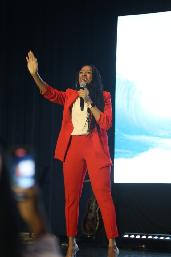 Shani Tené speaking in read suit